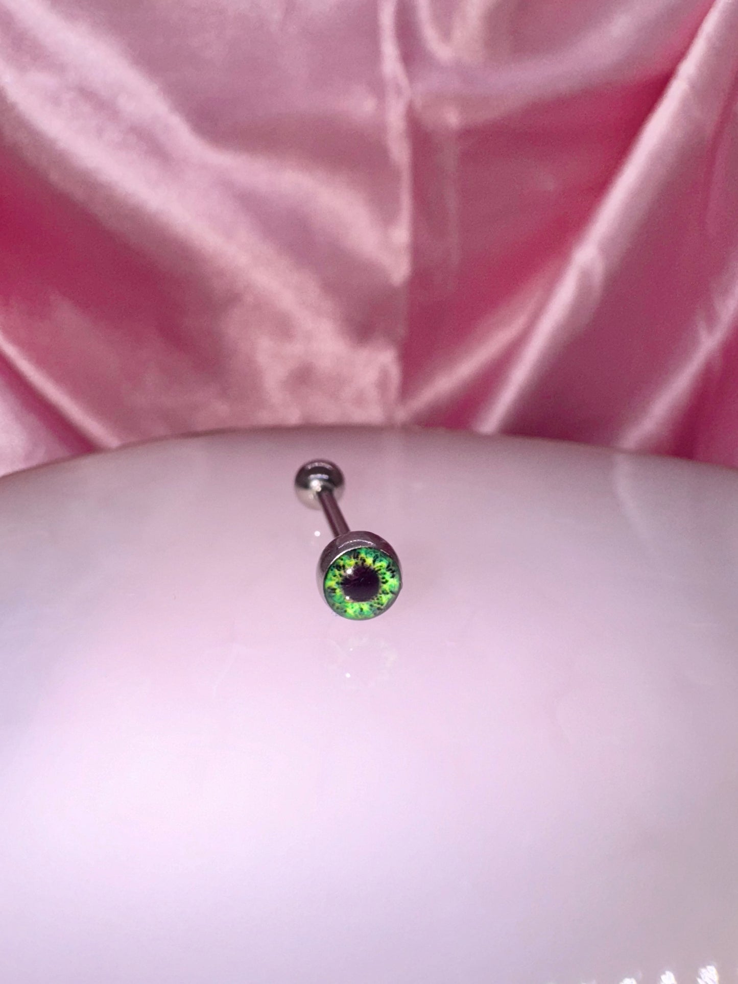 Green eye tongue ring